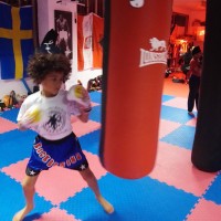 kids practice on boxing bag